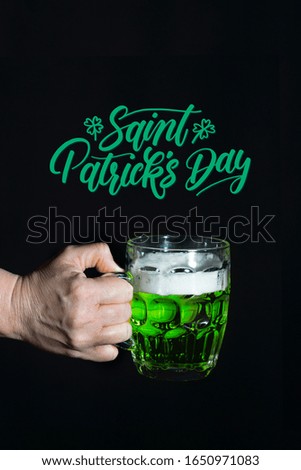 Holding a beer in saint patrick's day