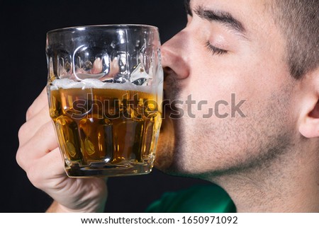 Man kissing a beer in Saint Patrick's day