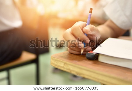 Blurred background of school concept, selective focused picture of writing activity in the lecture of of school, college, or university campus/ education or academic concept image related to training