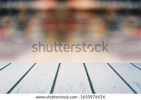 White Wooden Planks Table with Blurred Store on Background