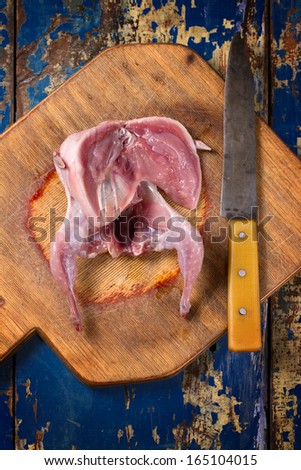Cutted quail on old wooden board