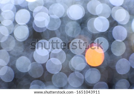 Diffused silver and white bokeh Black background at night