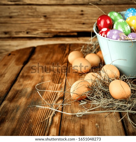 Wooden worn background of table and wall.Free space for your decoration.Fresh easter eggs and copy space for your product.Dark mood photo of spring time. 