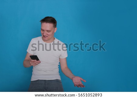 Portrait of a positive young boy on a bright blue background