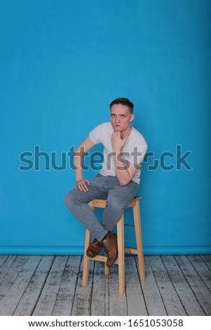 Portrait of a positive young boy on a bright blue background