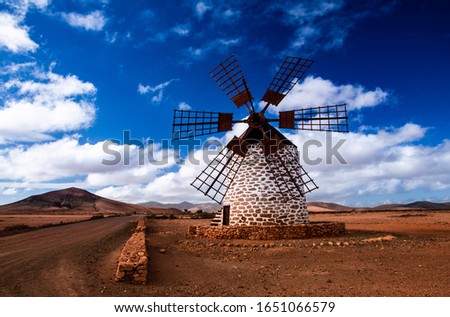windmill at Tefia, Fuerteventura, canary islands. clear clue sky with puffy clouds.