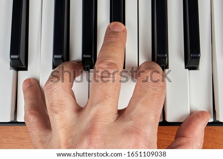 Hands playing piano keyboard or synthesizer