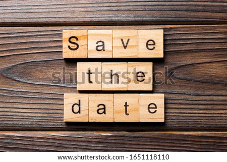 Save the Date word written on wood block. Save the Date text on table, concept.