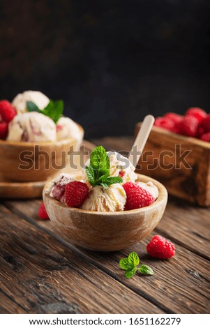 Summer ice cream with raspberry and mint on the wooden table, selective focus