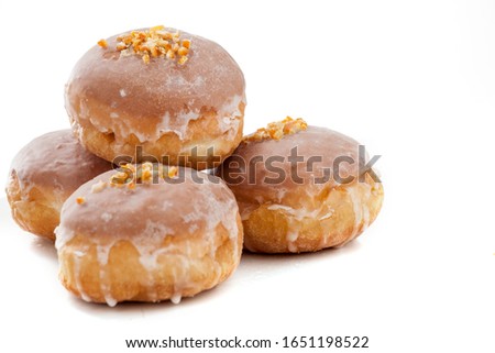 Donuts with icing on a white background, Fat Thursday Royalty-Free Stock Photo #1651198522