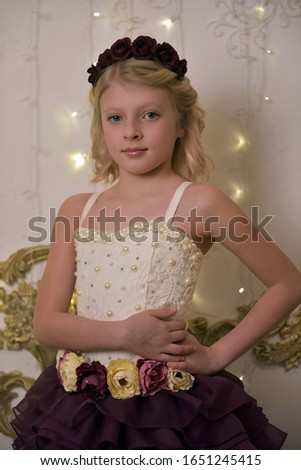 young blonde princess in elegant party dress, child