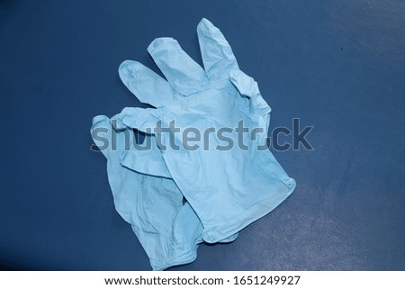 Blue nitrile medical gloves for virus prevention and protection laying on table