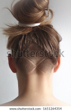 Young blond girl with a undercut hairstyle  Royalty-Free Stock Photo #1651264354