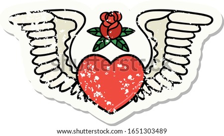distressed sticker tattoo in traditional style of a heart with wings