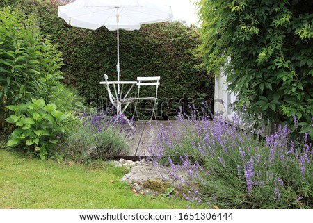 romantic place with lavender and white garden furniture.