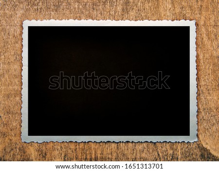 Blank old photo and space for text on a wooden background