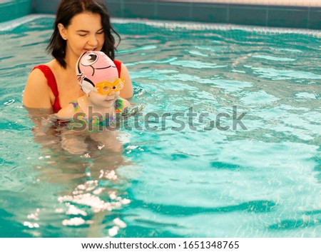 swimming lesson of young children in the pool, learning to swim in the childrens pool, early childhood development