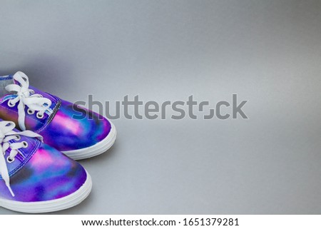 a pair of galaxy sneakers on the side side of a lead bottom