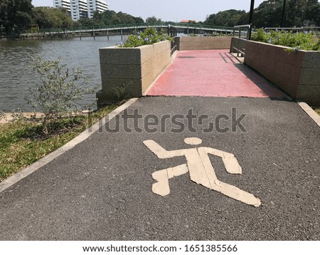 Running track with running sign on it's surface in public park in Bangkok,Thailand. 