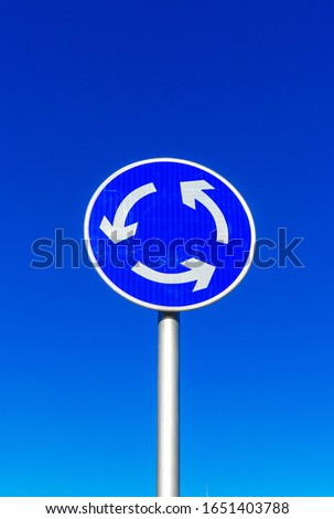 Blue sky with roundabout traffic symbol