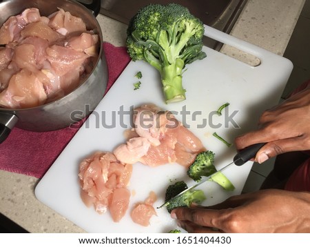 Cross contamination of food, raw and fresh vegetables are on the same chopping board Royalty-Free Stock Photo #1651404430