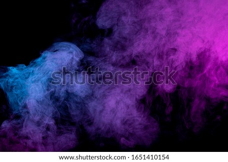 Pink and  blue  cloud smoke on black  isolated background. Fog colored with bright pink gel on dark background