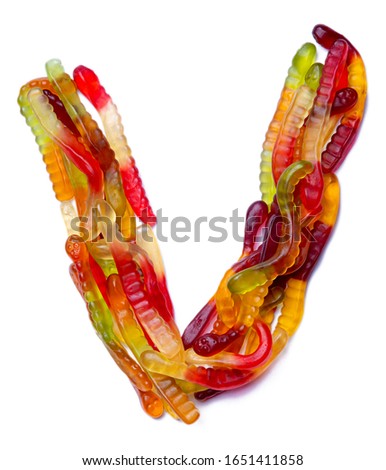 Letter V of the English alphabet  from multi-colored chewing marmalade on a white isolated background. Food pattern made ffrom children's sweets snakes. Bright alphabet for kids design