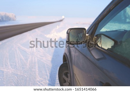 car mirror on the background of winter road