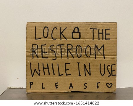 Courtesy, handwritten sign in restaurant restroom to remind user to lock the door behind themselves  