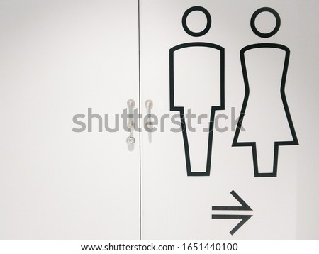 Male & Female toilet sign image or lined figure on white door wall background with direction arrow point to path way at  department store or shopping mall, restroom & bathroom concept, copy free space