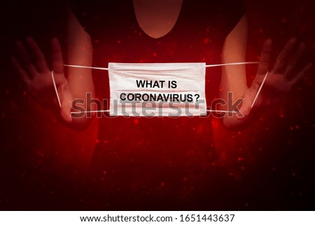 The concept of combating coronavirus.Women is showing a mask in her hands.What is virus.