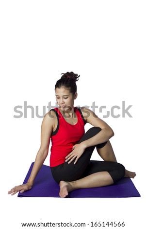 asian woman doing yoga against white background