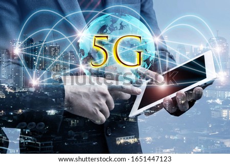 Double exposure of businessmen using tablet with growing globe animation model with 5G and connection line. Business for new mobile internet services are already on offer to connection