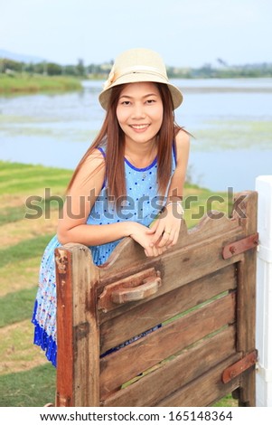 Young happy women or student on the lake background 