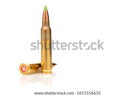 A pair of 5.56 calibar, green tip bullets ordered into the line on white background