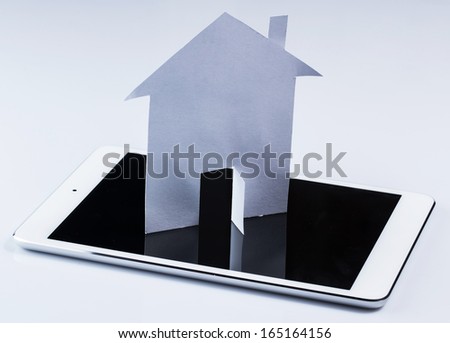 White tablet pc and paper house