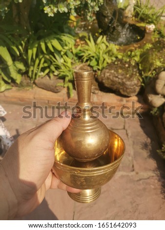 brass container filled in hand