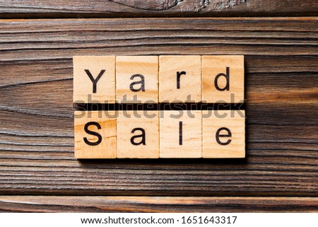 Yard sale word written on wood block. Yard sale text on wooden table for your desing, Top view concept.