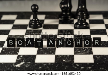 boat anchor concept represented by wooden letter tiles