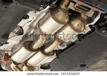 Catalytic converter. Exhaust system of a modern car bottom view. Royalty-Free Stock Photo #1651656655