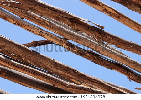 A wooden roof with blue sky background image. 