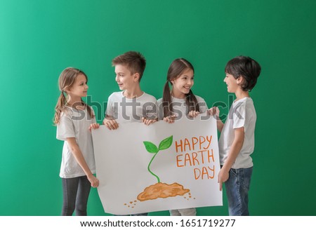Little children with drawing on color background. Earth Day celebration