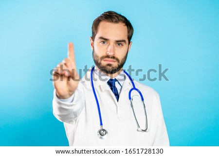 Doctor man disapproving with no hand finger sign make negation finger gesture. Denying, Rejecting, Disagree, Portrait of handsome guy