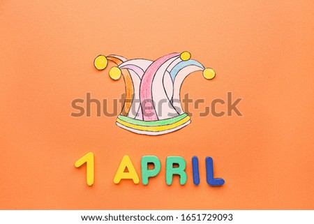 Fool's hat with date of April 1 on color background