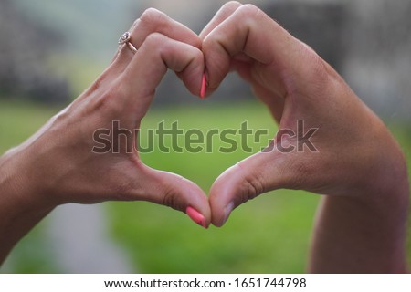 european people hands in shape of love heart. Couple in love making heart with hands 