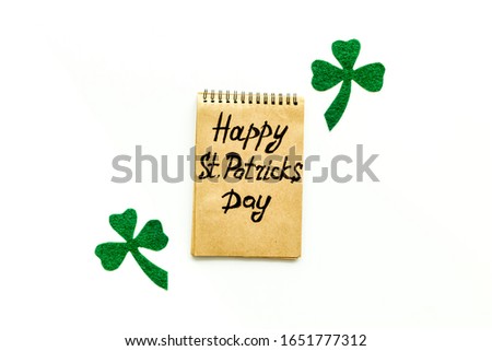 
Composition for St. Patrick's Day.
Decorating paper with green clover or shamrocks, leprechaun hat and horseshoe.
White background top view,flat lay, mockup