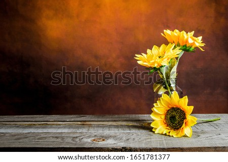 Beautiful sunflowers laying on a wooden table with vintage background