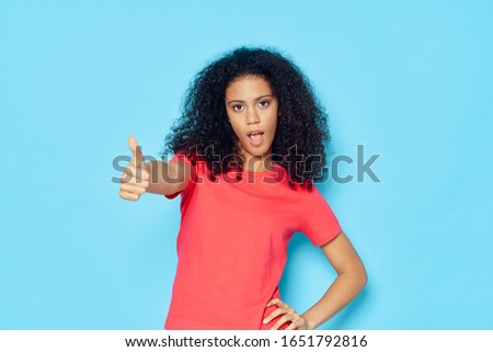 Beautiful woman curly hair emotions studio lifestyle blue background