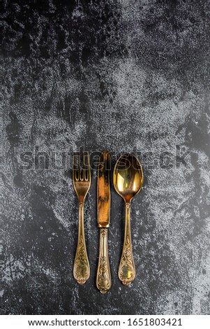 Vintage golden dinner set on a grundge blue background