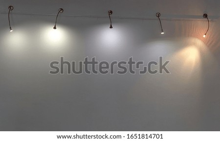 several lamps on a white wall. copy space